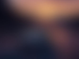 Car driving along a winding mountain road at sunset, glowing sky in oranges and purples, symbolizing freedom, adventure, and road trip vibes.