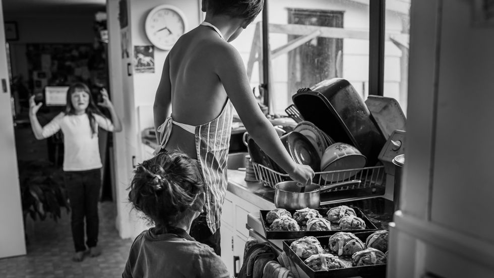 girl is angry and upset whilst brothers make hot cross buns