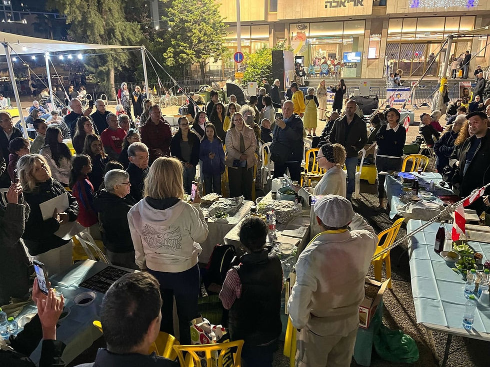 Rabbi Nathalie Lestranger in the center, leading the seder at Hostages Square