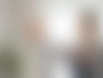 Physiotherapist supporting an older woman with balance and arm movement exercises during Parkinson’s physiotherapy in London