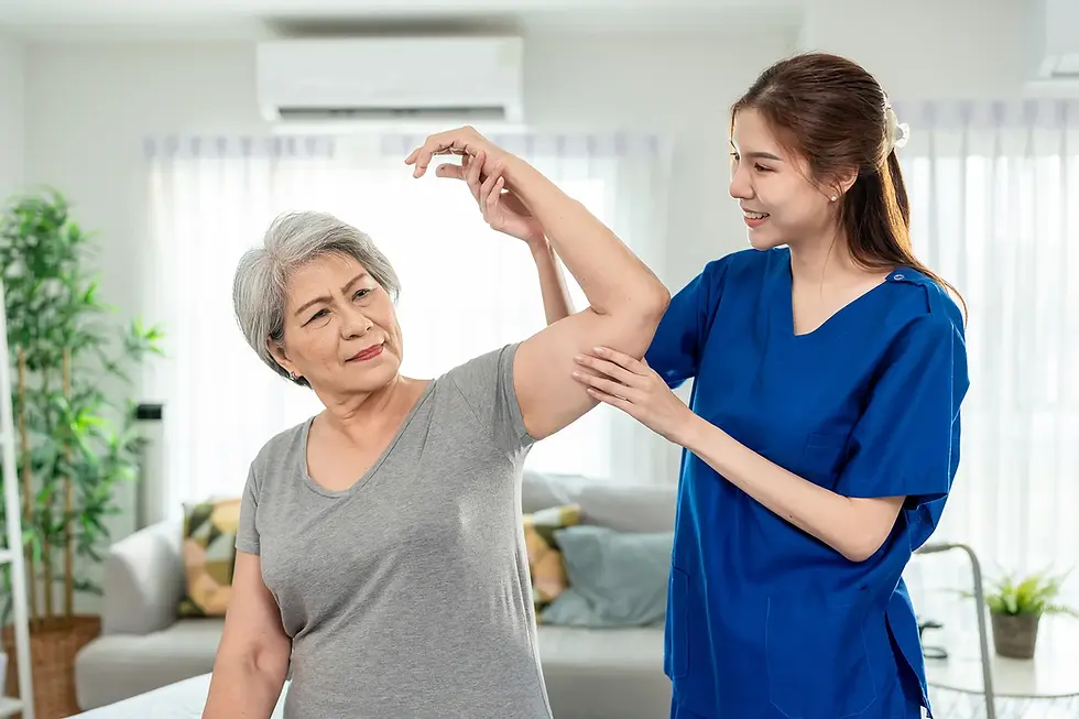Physiotherapist helping an elderly woman with shoulder movement exercises during a home physiotherapy visit in London