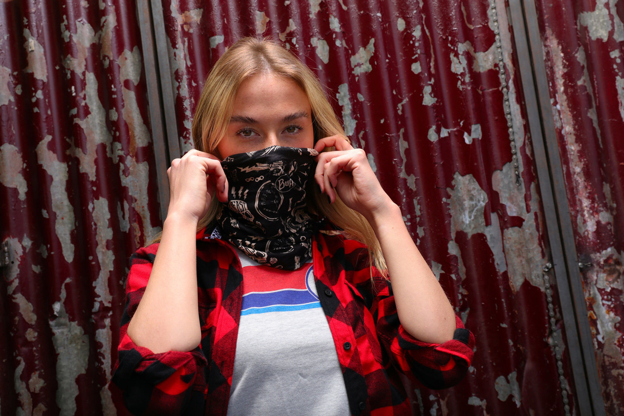 Woman Putting On a Red Torpedo AO Let's Go Buff