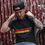 Thumbnail: Lee Johnston Wearing Red Torpedo Heritage 66 Men's Anthracite Tee Showing Front Stripe Design 