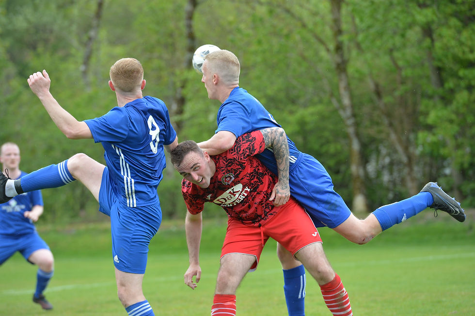 Aaron Moore tussles with Stuart Connelly and Thomas Duffy