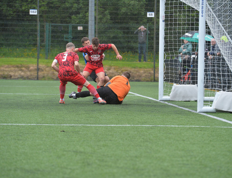 Craig Maitland holds onto Jordan Murphy's free-kick as Aaron McKay holds off Lee Dixon