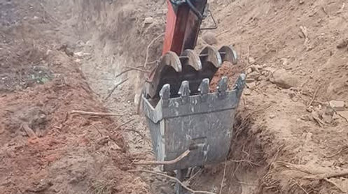 Excavator digging a trench for utilities installation in Sandpoint, Idaho, preparing the site for water, gas, or electric lin