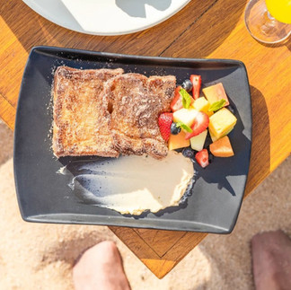 French toast served with sliced fruit from Milky Beach Club in Cabo, Mexico.