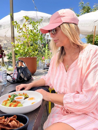 Woman dressed in pink enjoying brunch at Outpost in Cabo San Lucas, Mexico.