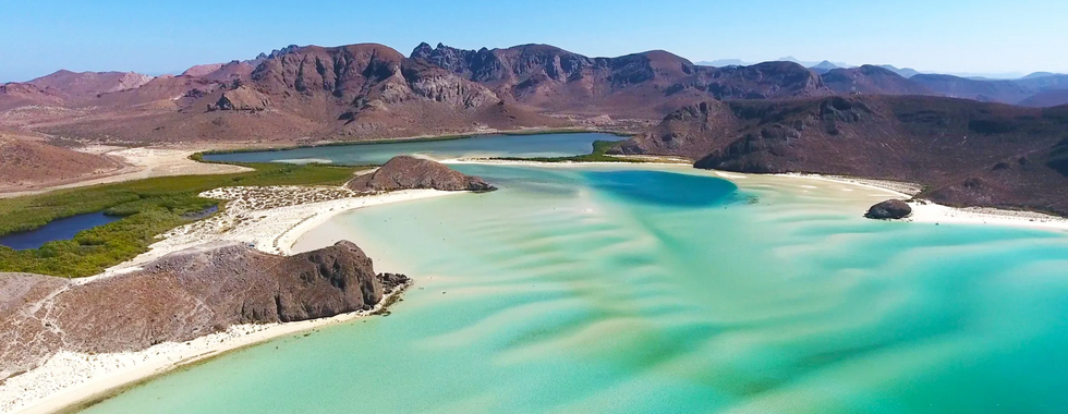 Beach of La Paz with white sand, and turquoise water. 