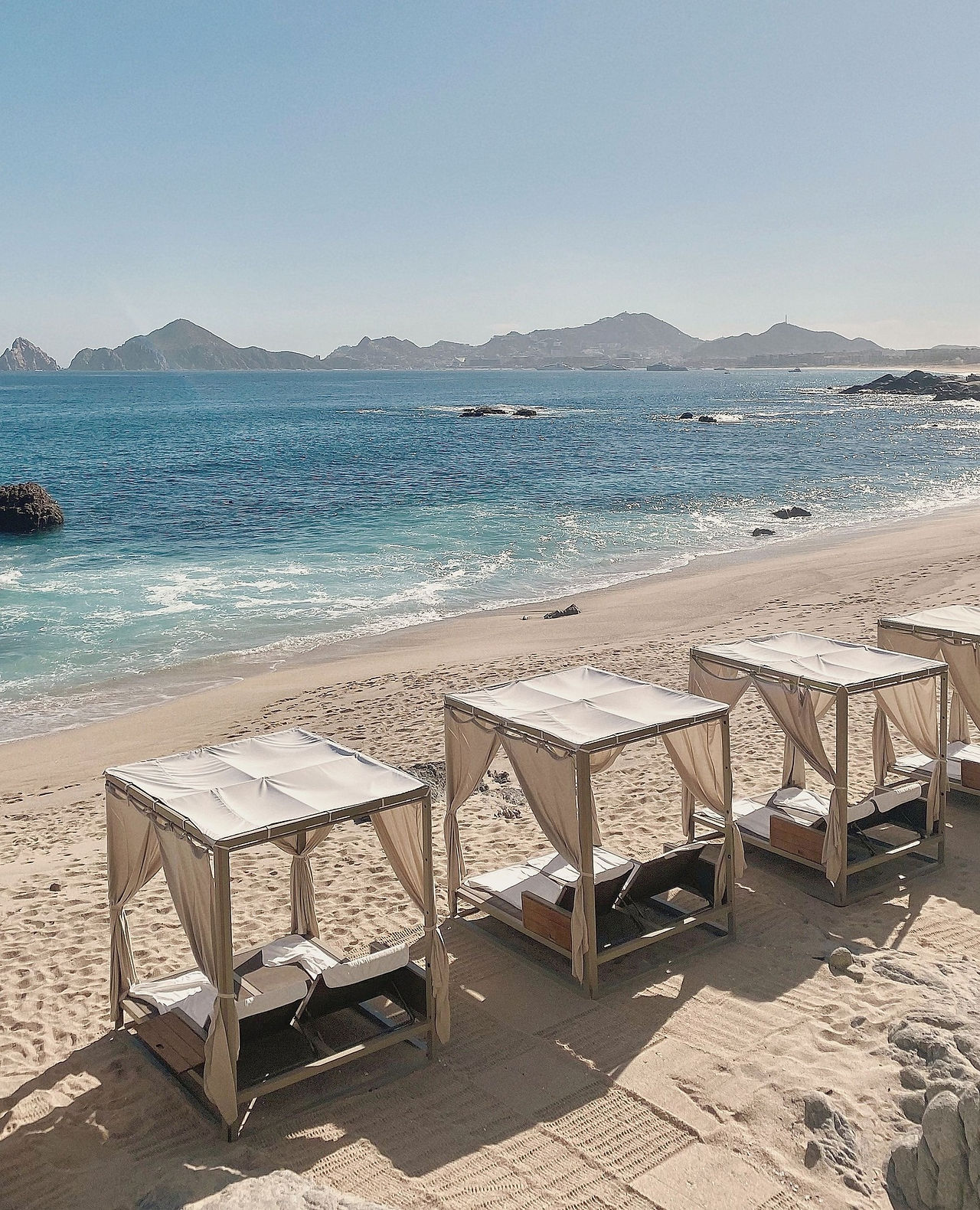 Beach at The Cape, A Thompson Hotel lined with cabanas for guests. 