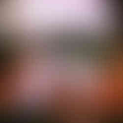 Couple enjoying the sunset on an outdoor lounge surrounded by candles and greenery in Bali.