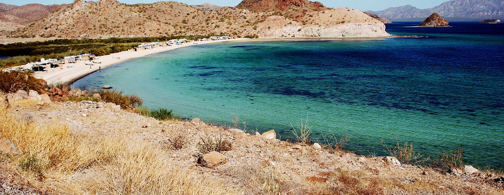 Beach of Mulege with people on the shore. 
