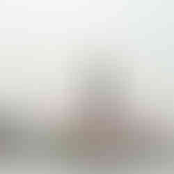 Temple in Thailand on a grey day, the structures reaching for the sky.