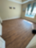 Detailed view of a wooden floor, highlighting its natural grain and texture in a warm hue.