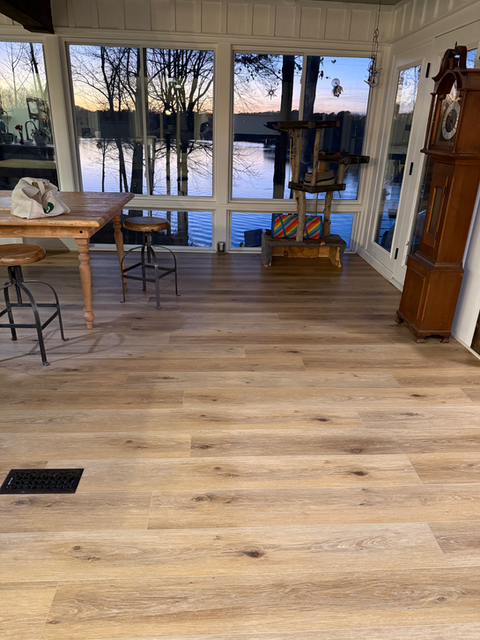 A detailed view of wooden flooring, featuring natural patterns and a glossy finish that enhances the room's ambiance.