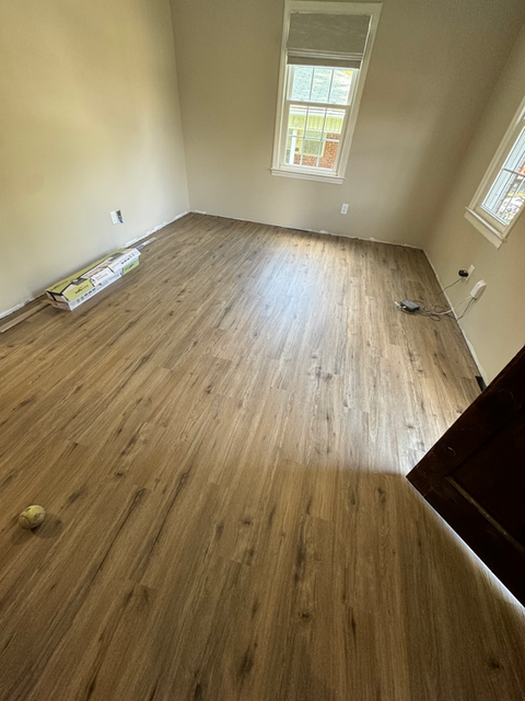  Close-up of polished wooden flooring showcasing rich grain patterns and warm tones.