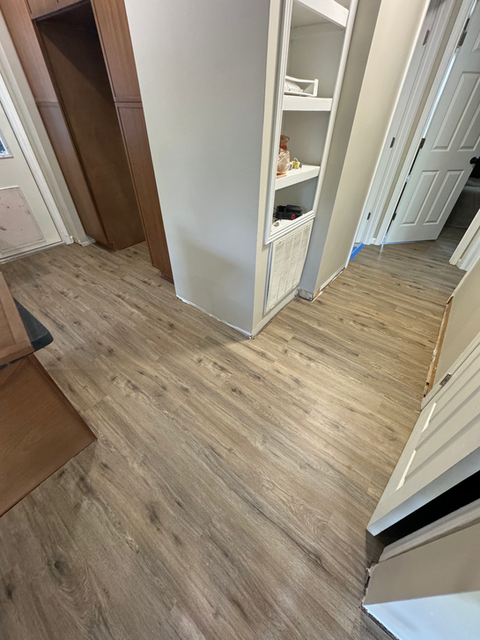  A section of wooden flooring displaying intricate grain patterns and a glossy surface.