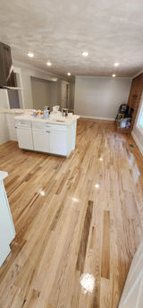 Close-up of a polished wooden flooring, showcasing its rich grain and warm tones.