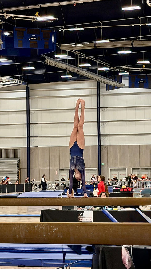 GymWorld gymnasts competing at a USAG gymnastics meet on Beam