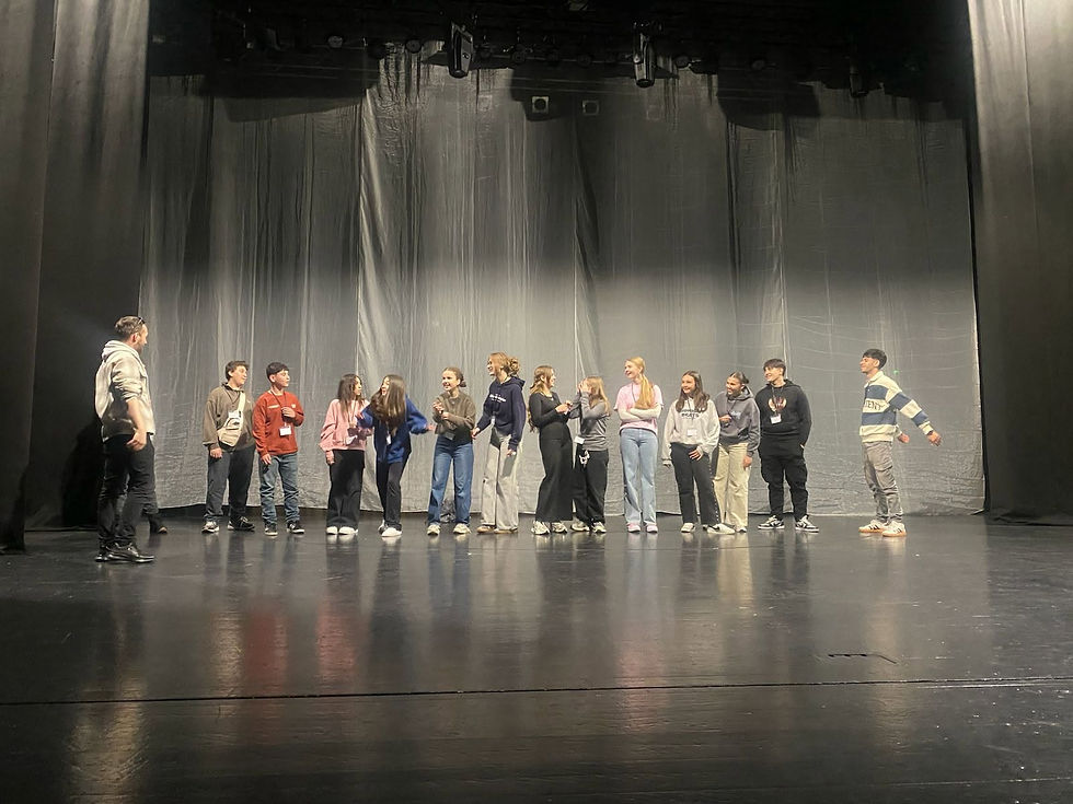 Eye-level view of students taking part in a drama movement activity.