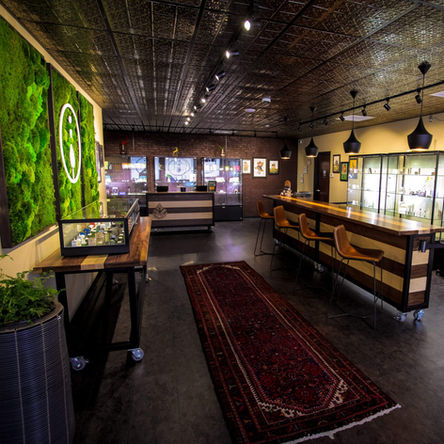 a photo of a wooden table with a floral art piece on the wall behind it