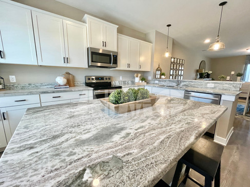 Modern kitchen featuring Fantasy Brown Marble countertops and island by Aravali Marbles, combining timeless natural beauty with exceptional durability.