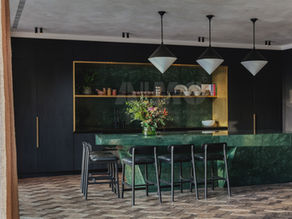 Aravali Marbles Green Marble kitchen interior featuring a luxurious green marble island countertop and backsplash with rich natural veining, complemented by dark cabinetry, modern pendant lighting, and elegant contemporary design. Premium Indian Green Marble showcased for residential and commercial architectural applications.