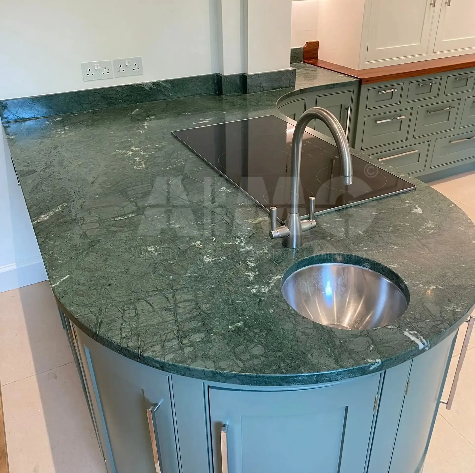 Indian Green Marble kitchen countertop with polished surface, natural veining, curved edge detailing, and integrated sink, showcasing its suitability for durable and premium kitchen applications, supplied by Aravali Marbles, Udaipur.