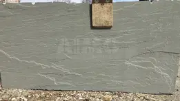 Rough-textured beige sandstone slab with subtle horizontal layering.