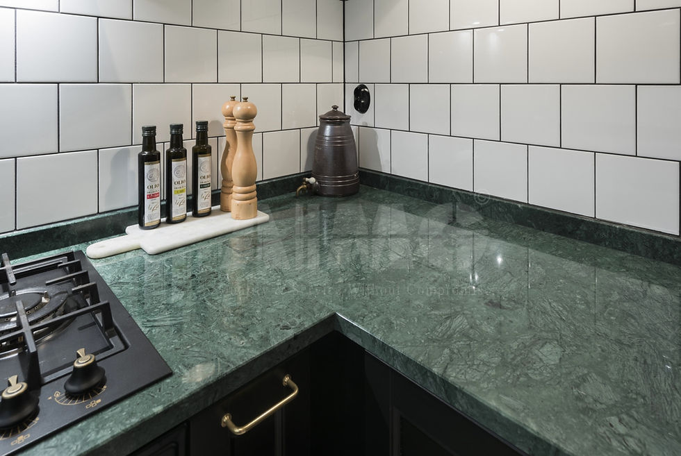Green marble kitchen countertop by Aravali Marbles with glossy finish and modern backsplash