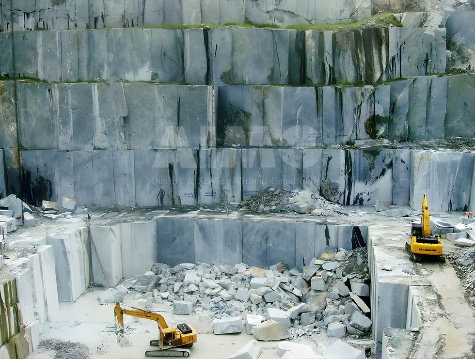 Green marble quarry in Rajasthan, India, showcasing large extracted blocks of premium Indian Green Marble (Verde Guatemala Marble) with excavation machinery in operation. Image by Aravali Marbles, a leading manufacturer and exporter of green marble from India.
