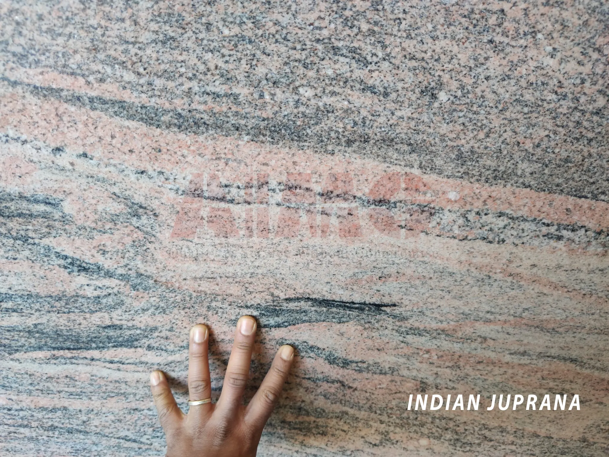 Indian Juprana Pink Granite by Aravali Marbles with flowing pink and grey wave patterns ideal for premium kitchen countertop designs