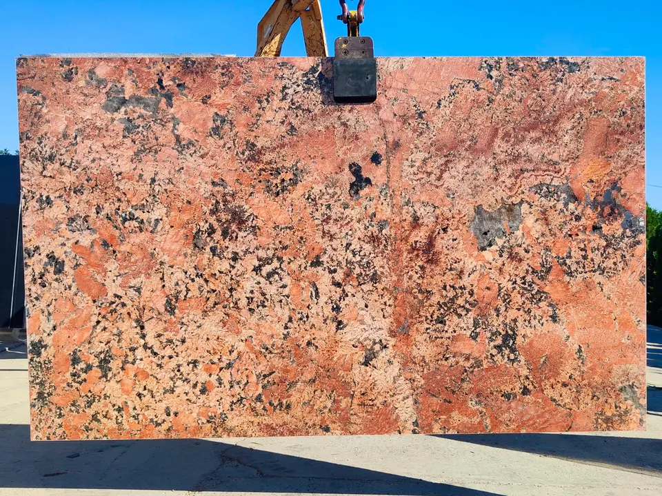 Alaska Red granite slab displayed outdoors by Aravali India Marbles and Granites.