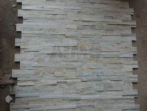A collection of stacked Himachal White Quartzite stone, ready for international export from Aravali India Marbles & Granites.