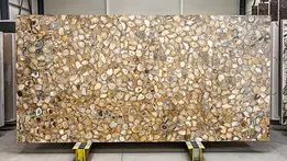 Decorative semi-precious stone slab made of polished circular agate slices in various shades of brown and beige.