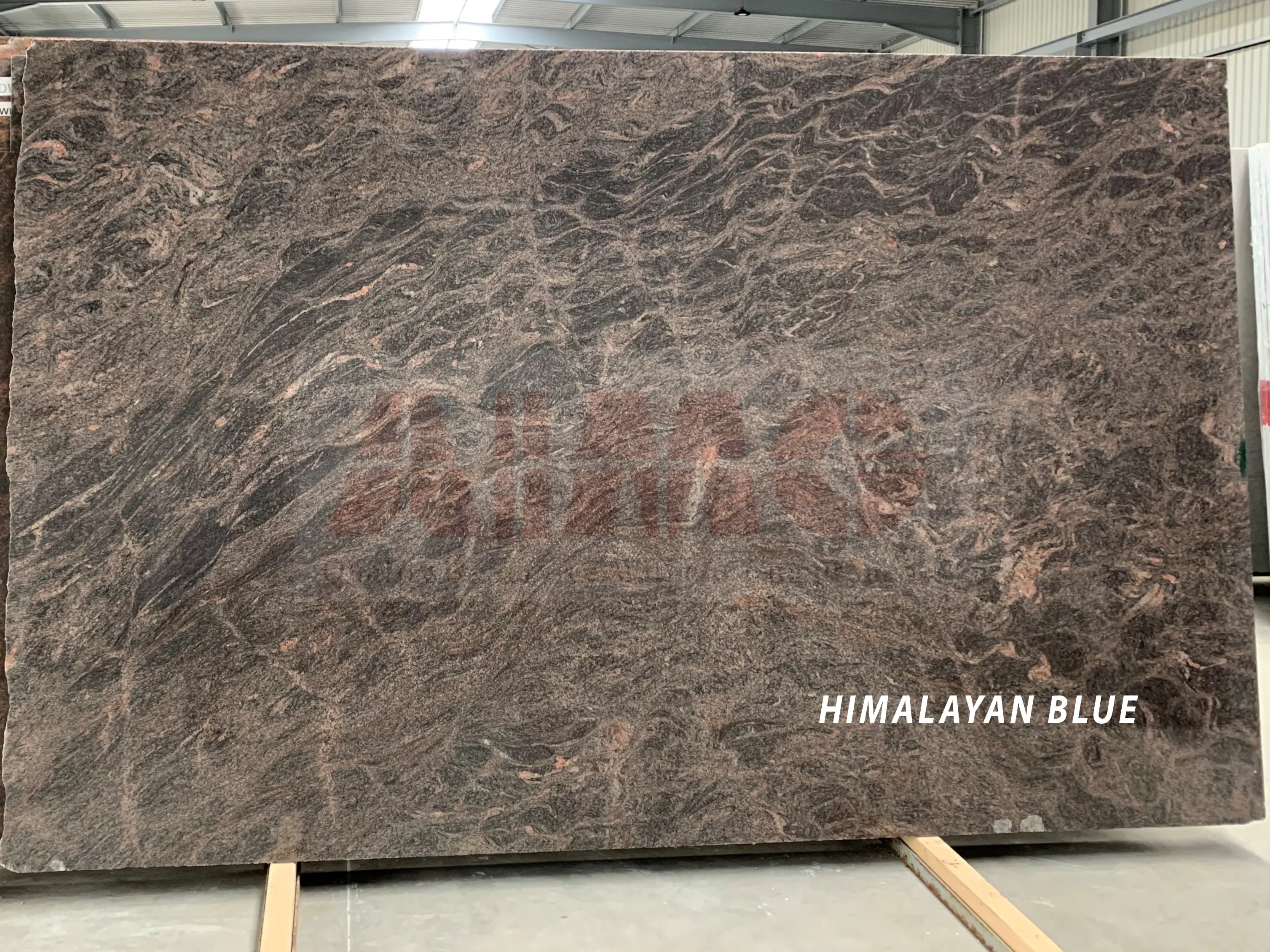 Himalayan Blue Granite slab by Aravali Marbles with natural flowing veining and earthy blue tones for premium kitchen countertops
