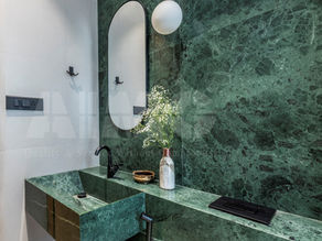 Green marble bathroom vanity by Aravali Marbles with polished stone sink and wall cladding