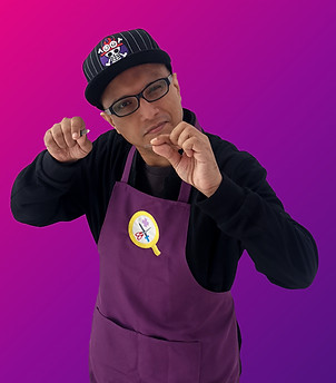 A half-body portrait of BlackKri, a mix-Indian male in his 40's. He is clean-shaven, and wearing a cap with the One Piece crossbones on it. He is wearing a long-sleeved black top underneath the Qiqi's Cosplay Medics purple apron. His expression is serious and focused, as he holds a pair of tweezers in his left hand, and a nail filer in the right.