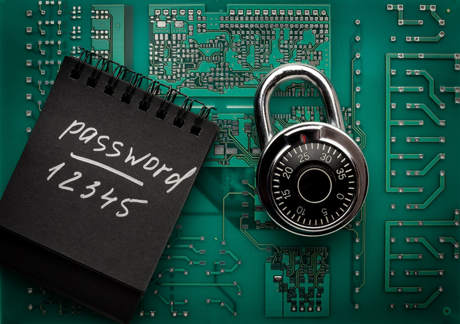 Photo of circuit board with padlock and notebook on top
