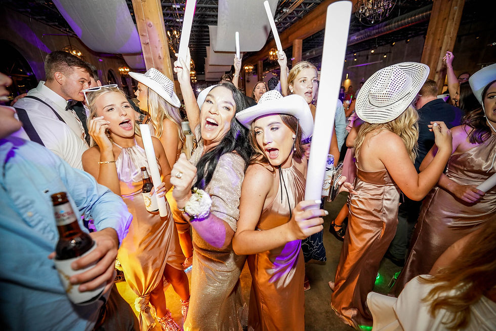 Bridesmaids dancing with glow sticks on the wedding dance floor at Park Crest Event Facility