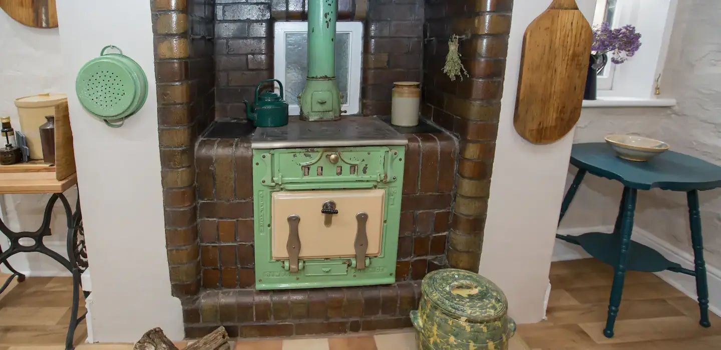 Vintage wood stove in the Burra House kitchen, adding rustic charm to your South Australian heritage getaway experience.