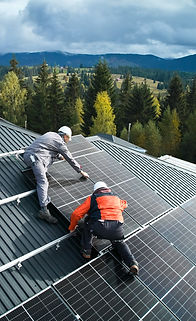 Electricians building photovoltaic solar module station on roof of house. Men technicians 