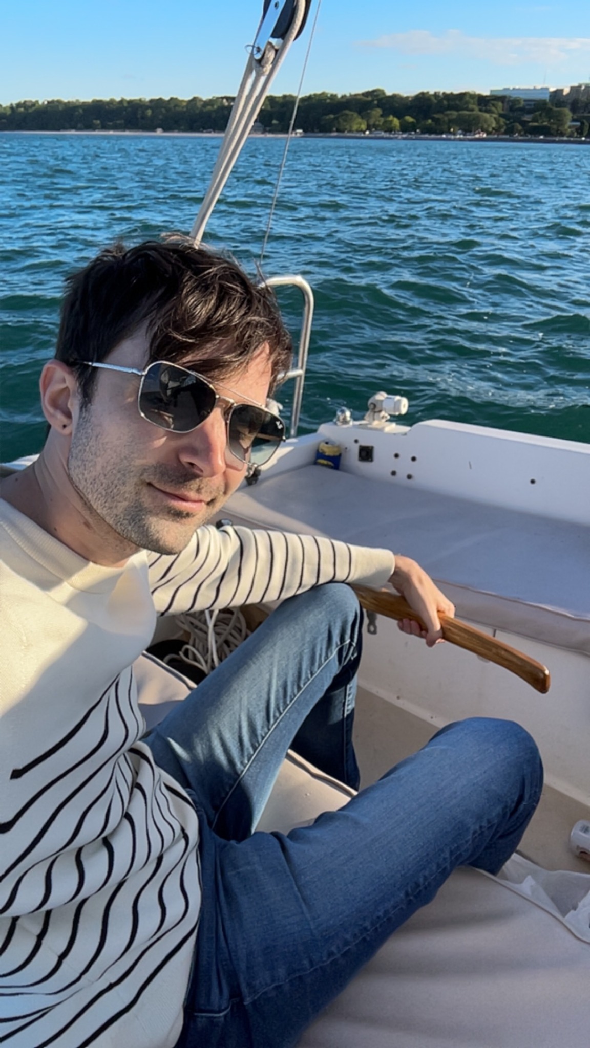 Nemanja Vuksanovic seated on a boat on the water.
