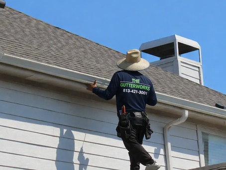 on top of the roof Installing gutters, the gutterworks co.