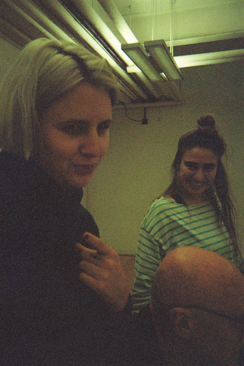 Leo and Mel smiling coyly at the camera. Leo's pointing, Tim's head is between us.