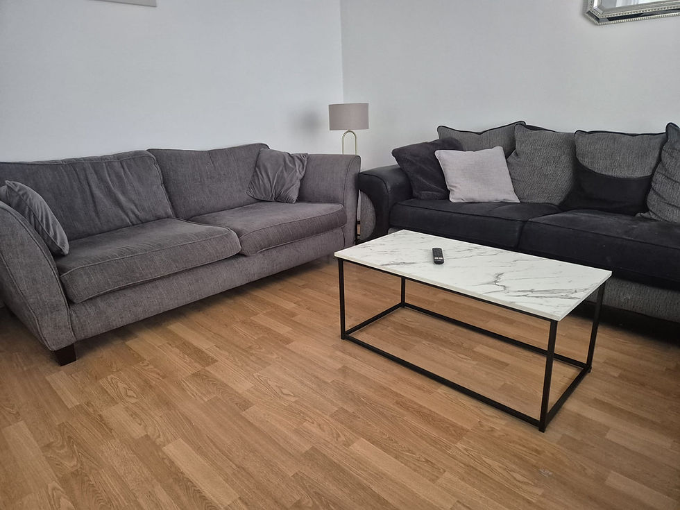 Modern Harlech living room with grey sofas and marble table