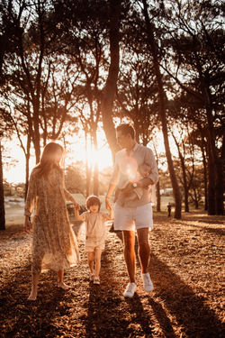 Sunset photo of a family of four going for a walk