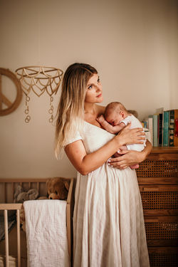 Mother and her newborn son in his nursery