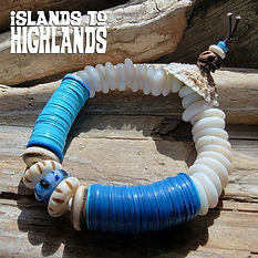 Photo of the Islands To Highlands Aruba Bracelet on a piece of driftwood.