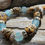 Thumbnail: Photograph of the Islands To Highlands Honolulu Elks Lodge 616 Bracelet on a piece of driftwood.